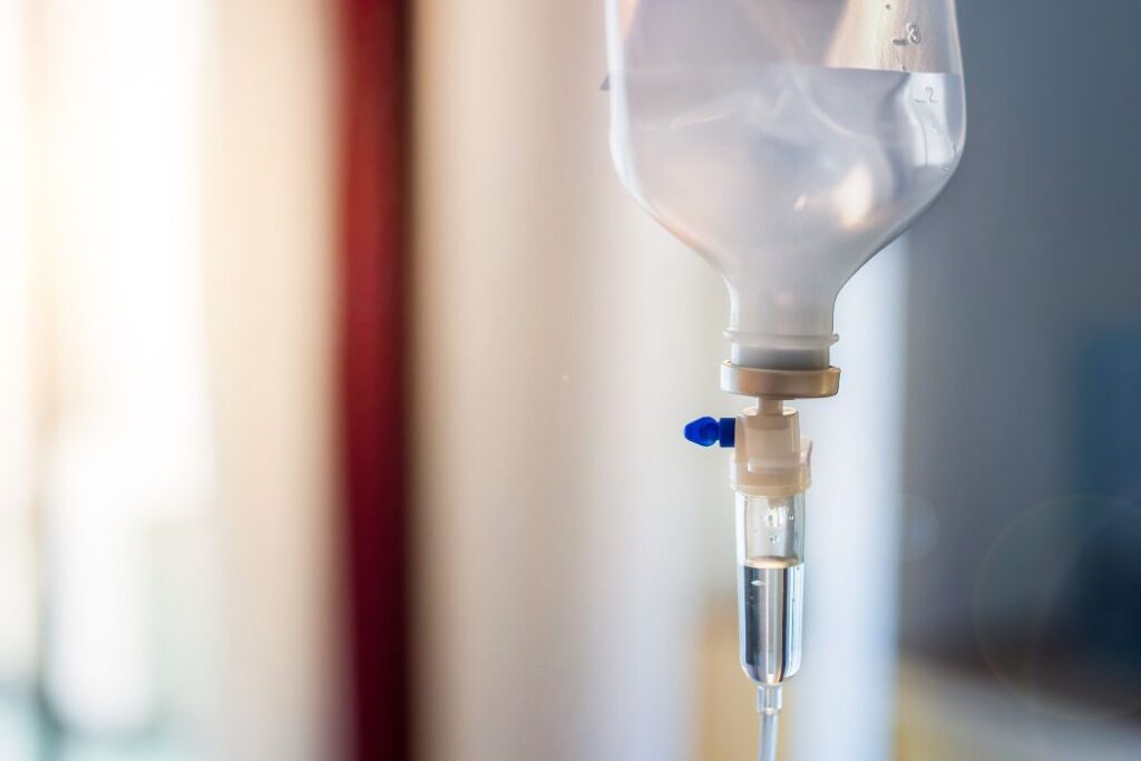 Close up of medical drip or IV drip chamber in patient room