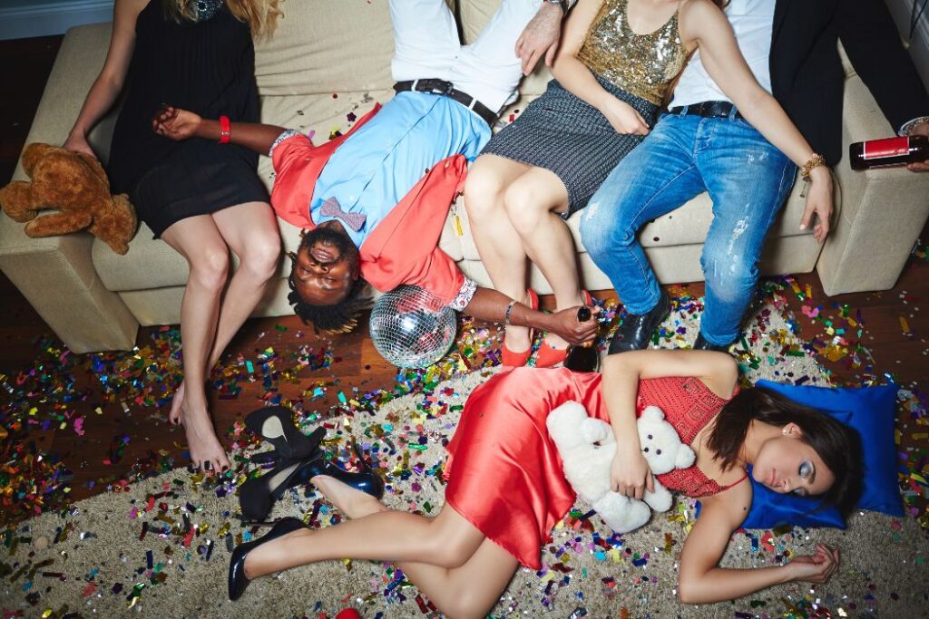 Drunk group of friends with confetti around them. how much wine to drink to get drunk