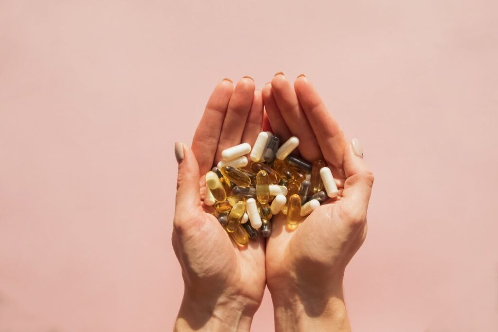 hand full of medicine capsules