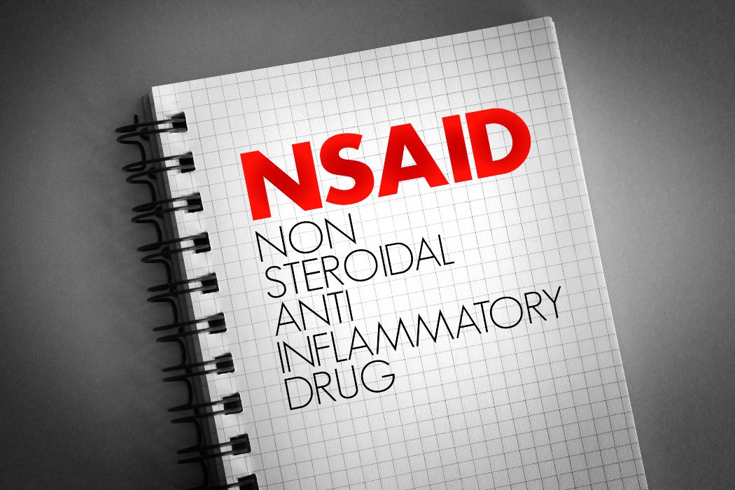 NSAID - nonsteroidal anti-inflammatory drug acronym on notepad, concept background